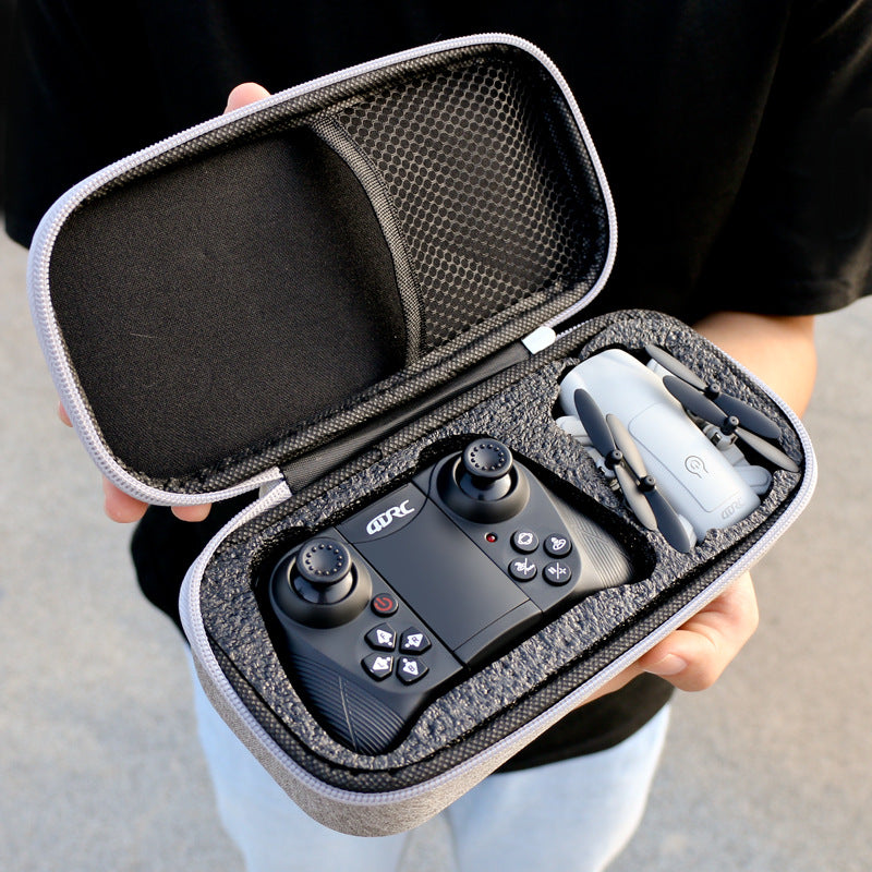 Foldable mini quadcopter drone with HD camera and remote control transmitter in black. — view 3