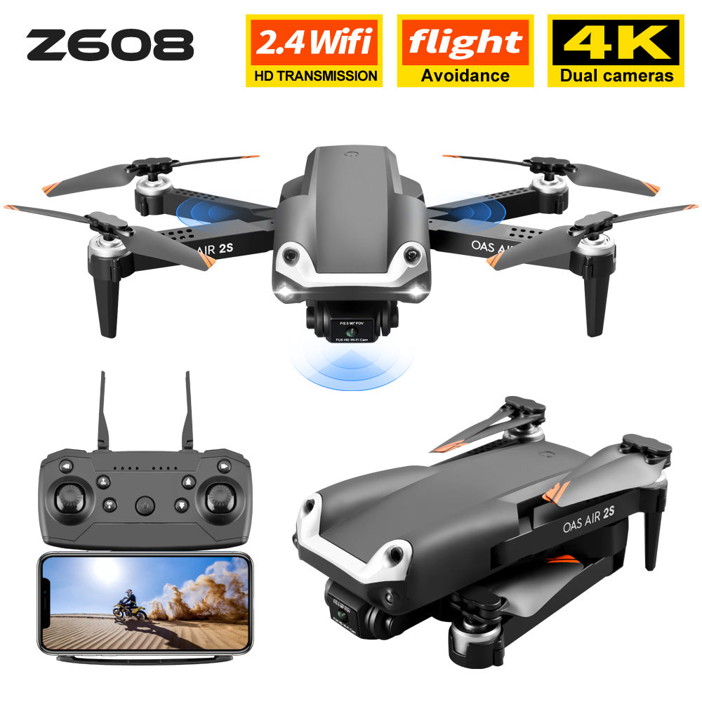 Black folding 4K dual camera drone with remote control and propellers extended for flight — view 3