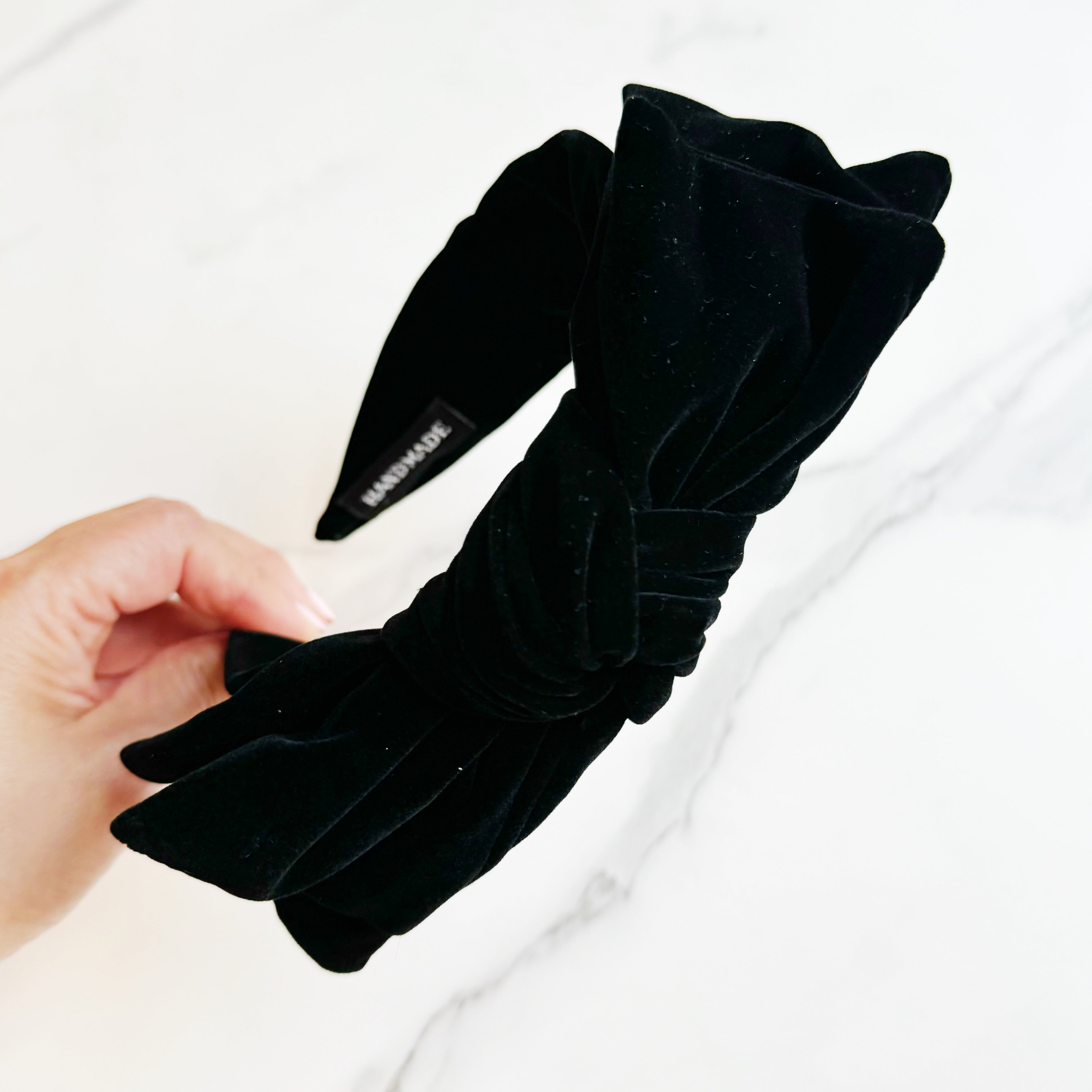 Structured velvet bow headband in a classic elegant style for sophisticated hair styling — view 2