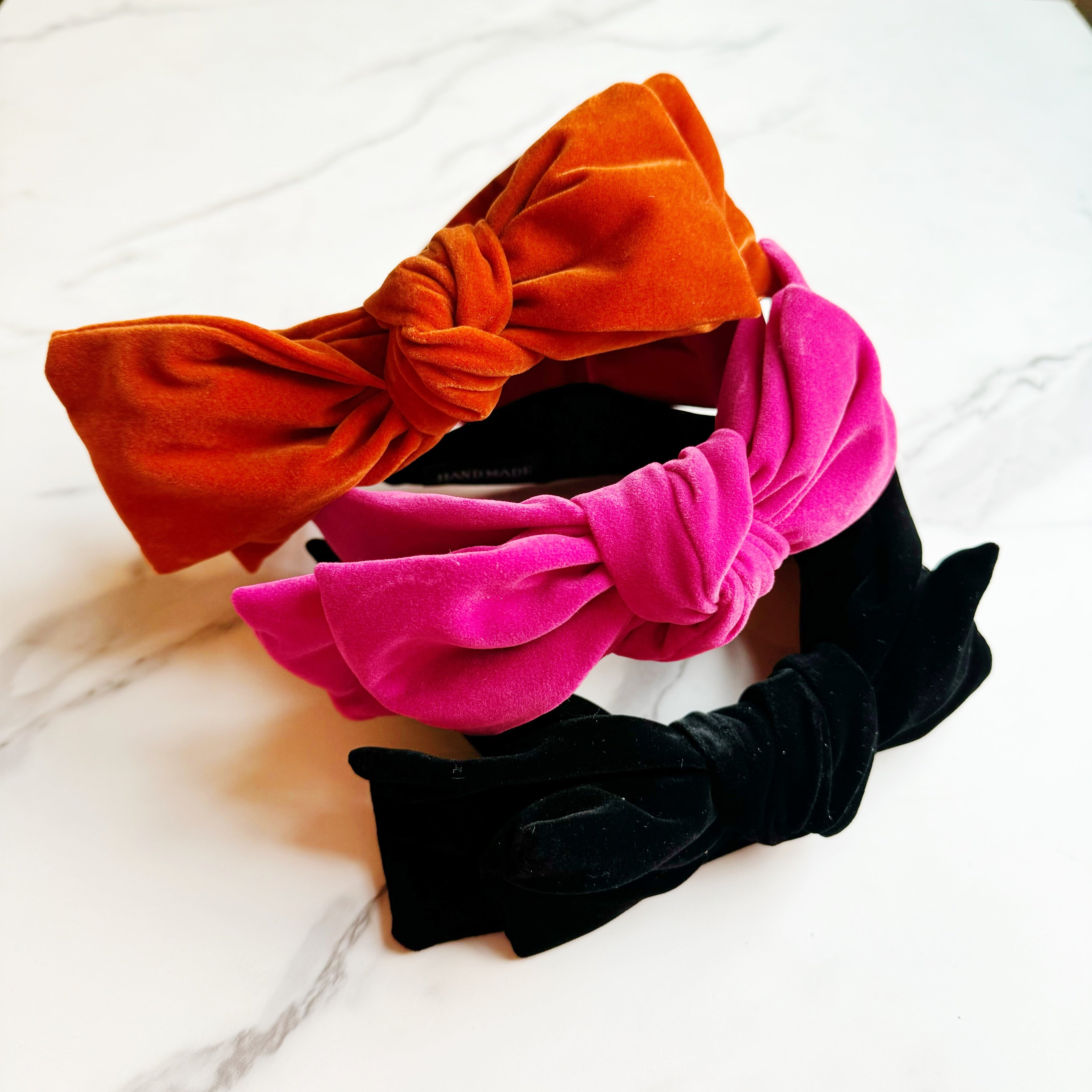 Structured velvet bow headband in a classic elegant style for sophisticated hair styling