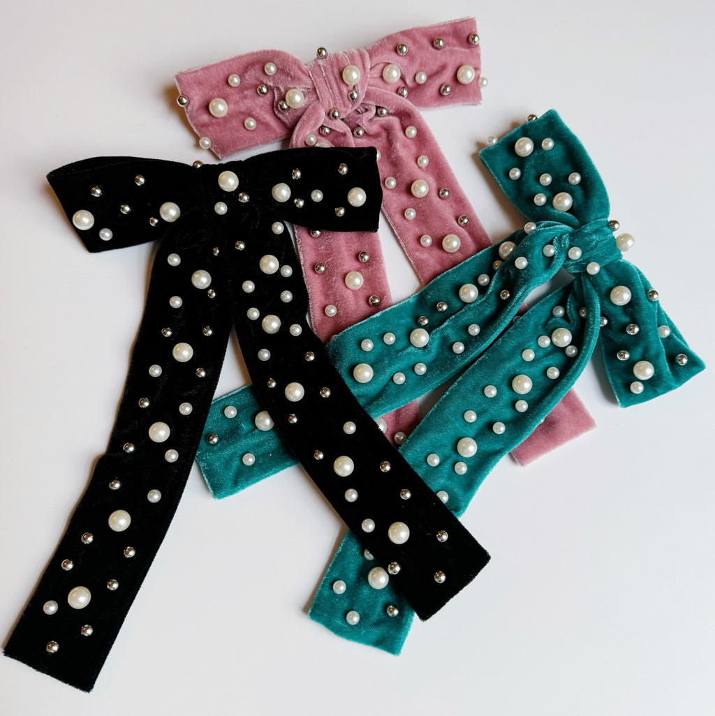 Pearl velvet bow hair clip with an elegant oversized design and secure clasp for styling.