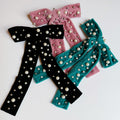 Pearl velvet bow hair clip with an elegant oversized design and secure clasp for styling.