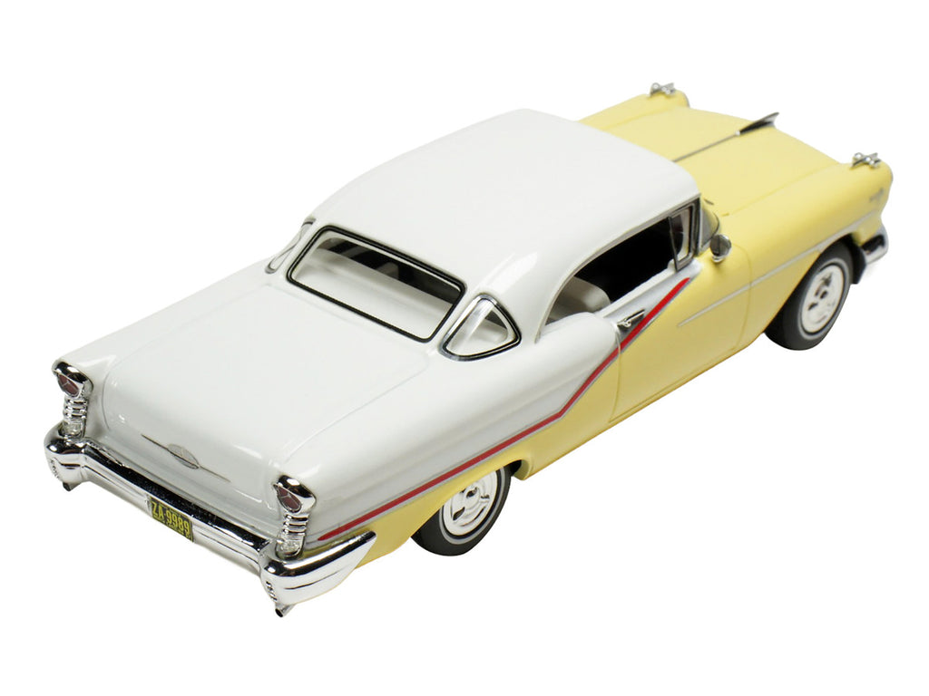 1957 Oldsmobile Starfire 1/43 scale resin model car in yellow and white with clear display — view 2