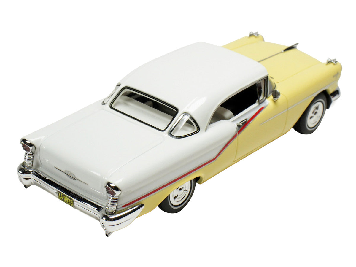 1957 Oldsmobile Starfire 1/43 scale resin model car in yellow and white with clear display — view 2