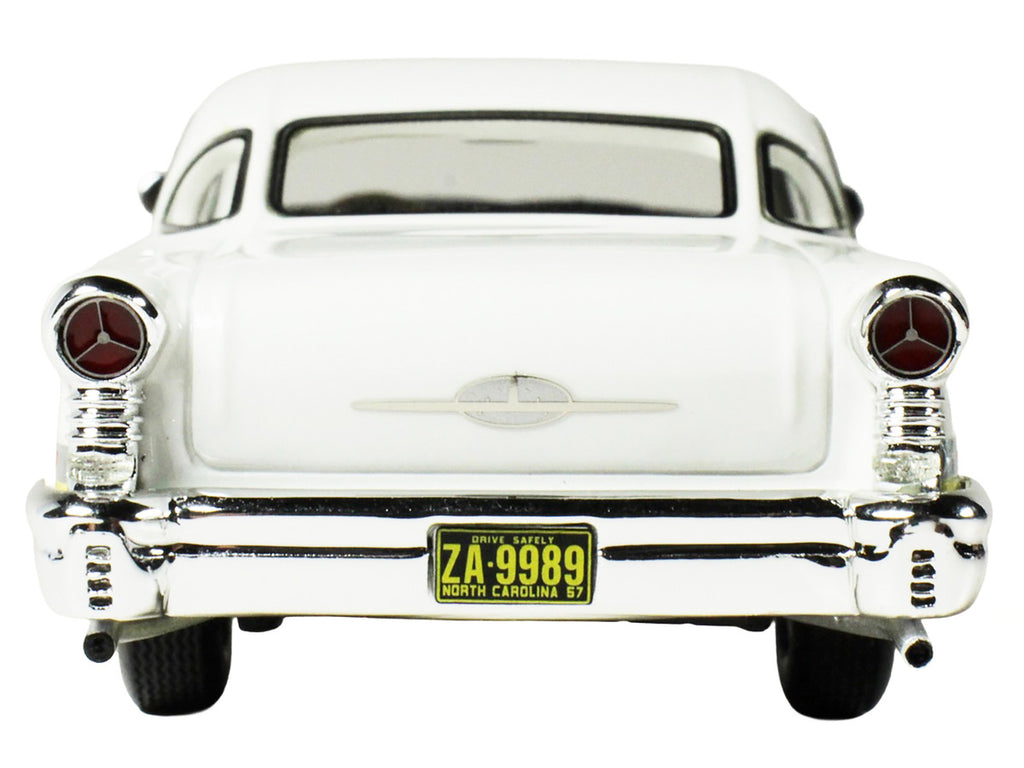 1957 Oldsmobile Starfire 1/43 scale resin model car in yellow and white with clear display — view 4