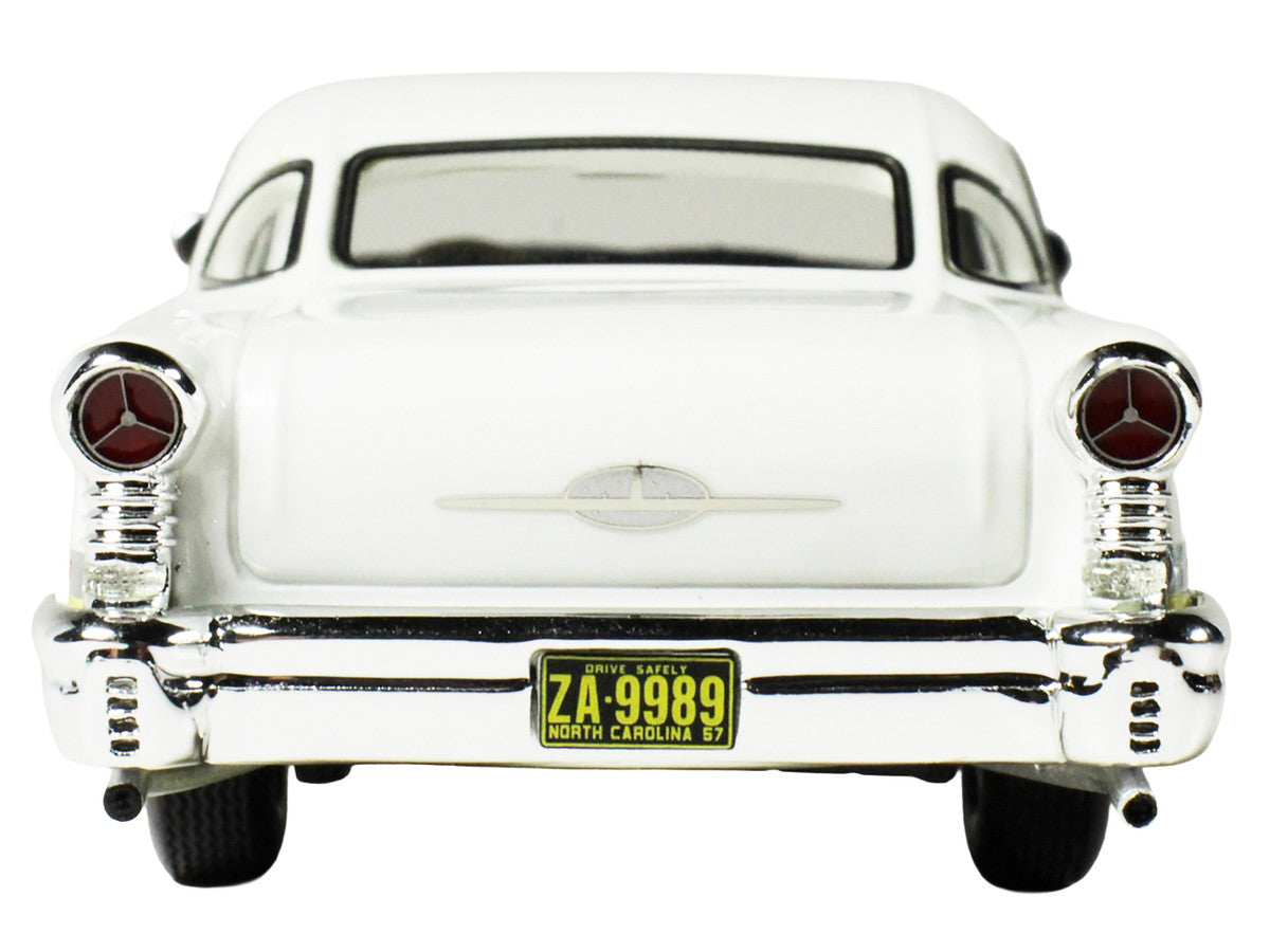 1957 Oldsmobile Starfire 1/43 scale resin model car in yellow and white with clear display — view 4
