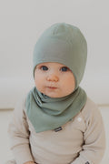 Ribbed cotton baby hat with secure chin ties and ear protection flaps for newborns.