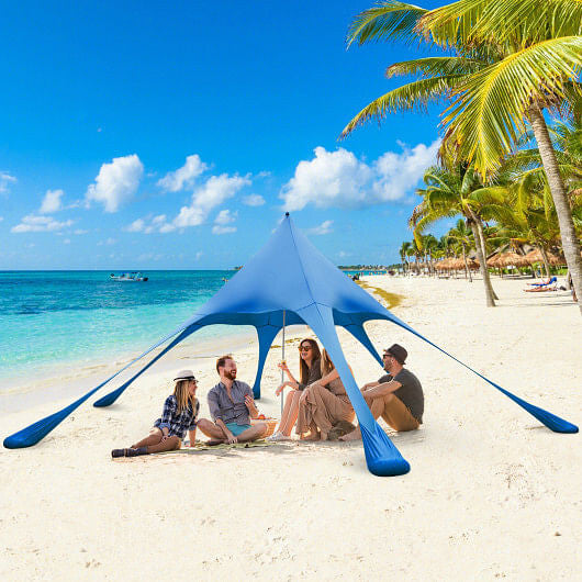 Blue 20x20 beach canopy tent with UPF50 sun protection, sandbags, and aluminum poles setup outdoors — view 3