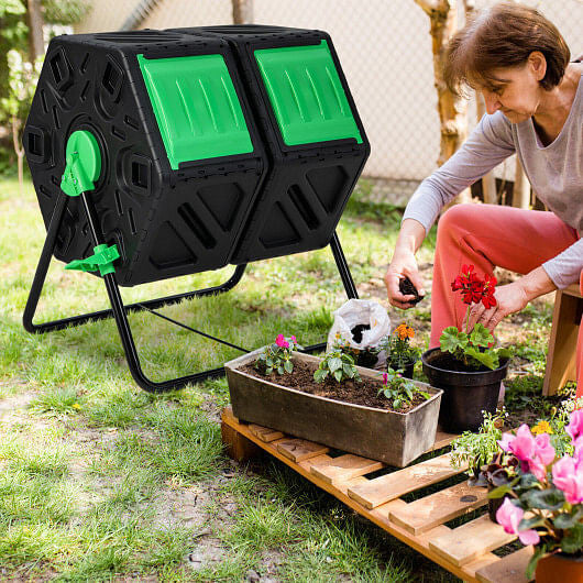 Black and green dual chamber rotating compost tumbler on a sturdy powder-coated metal frame.