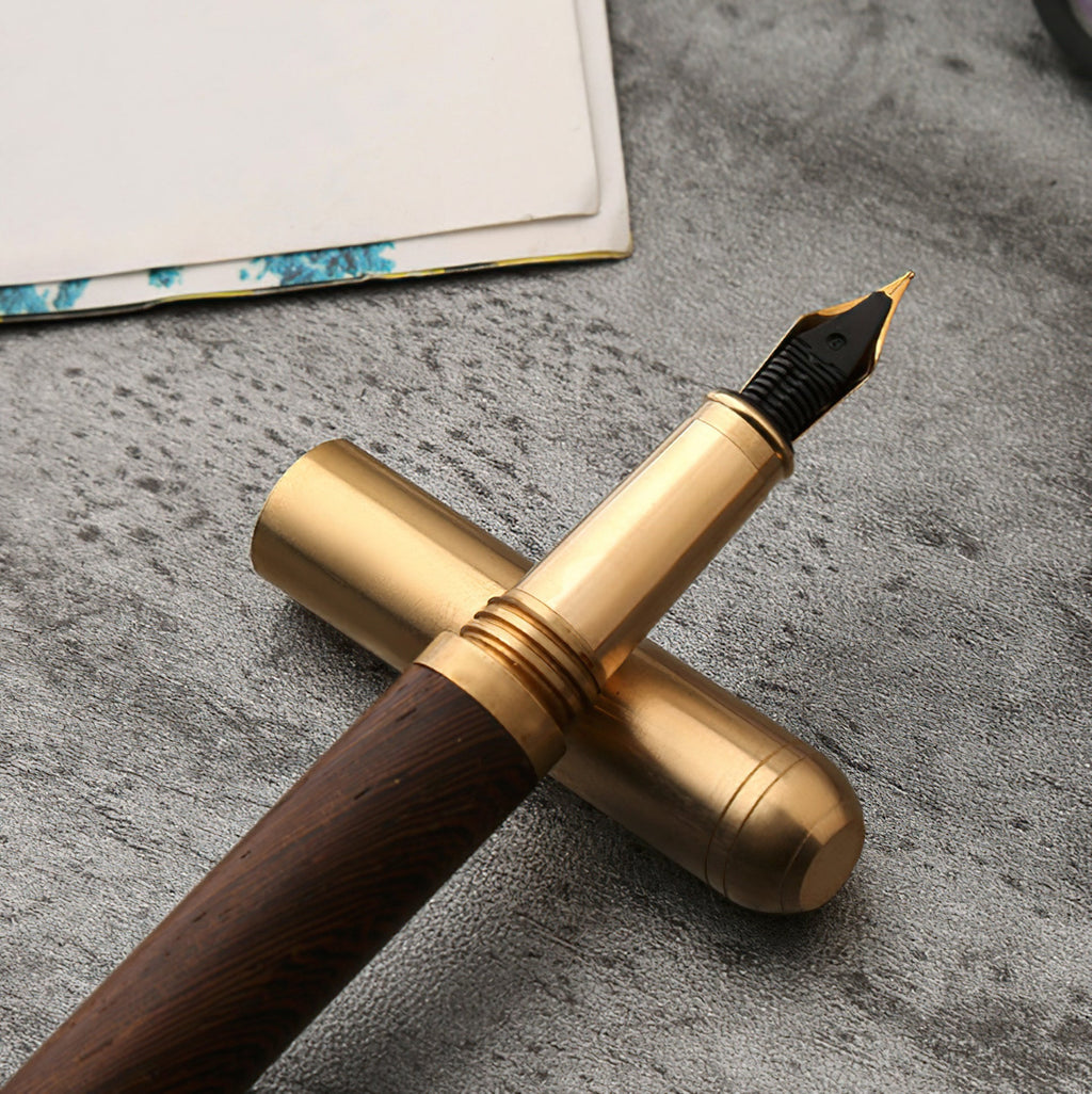 Handcrafted solid wood and brass fountain pen with a fine iridium nib on a desk — view 3