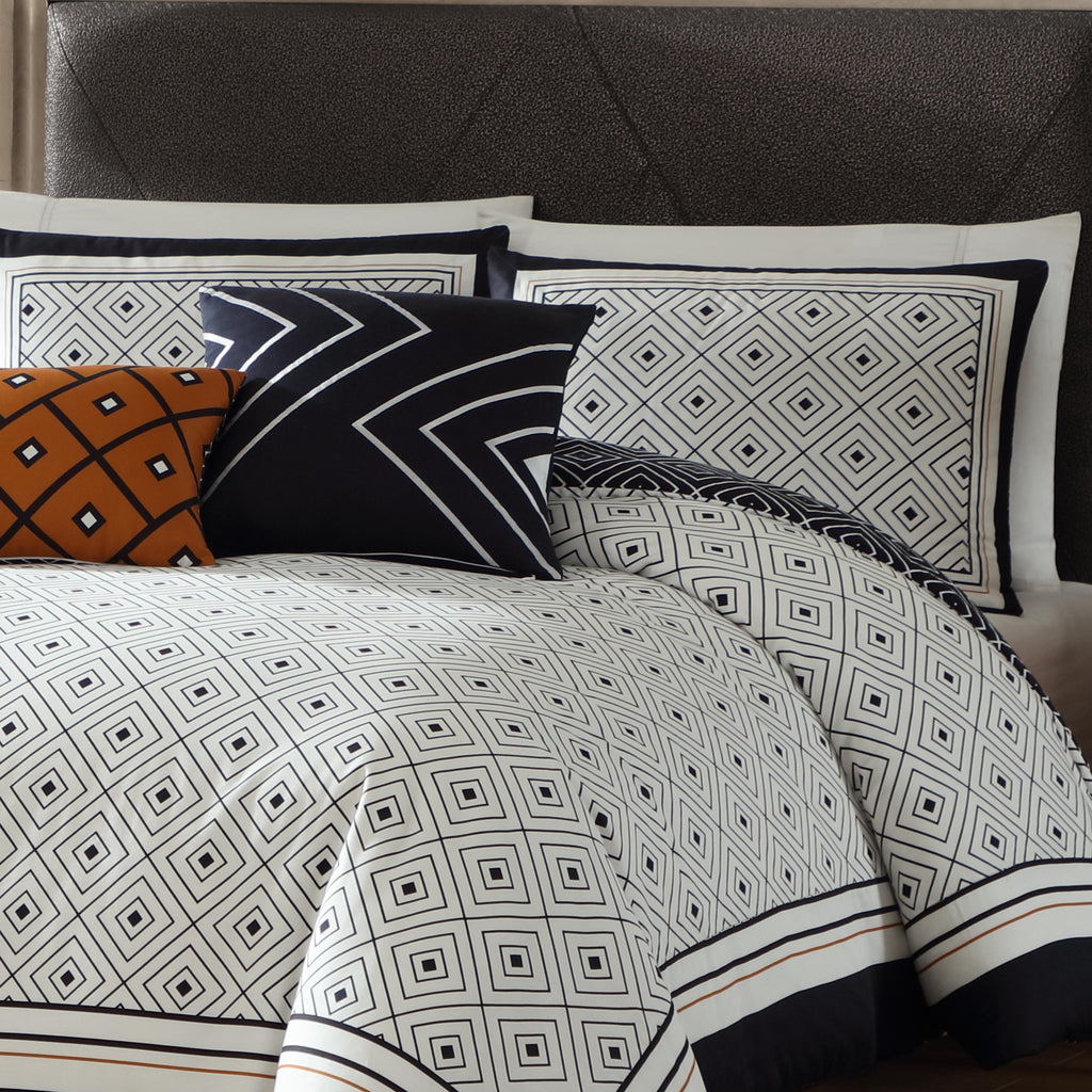 Black and white geometric reversible cotton comforter set with shams and decorative pillows on bed — view 3