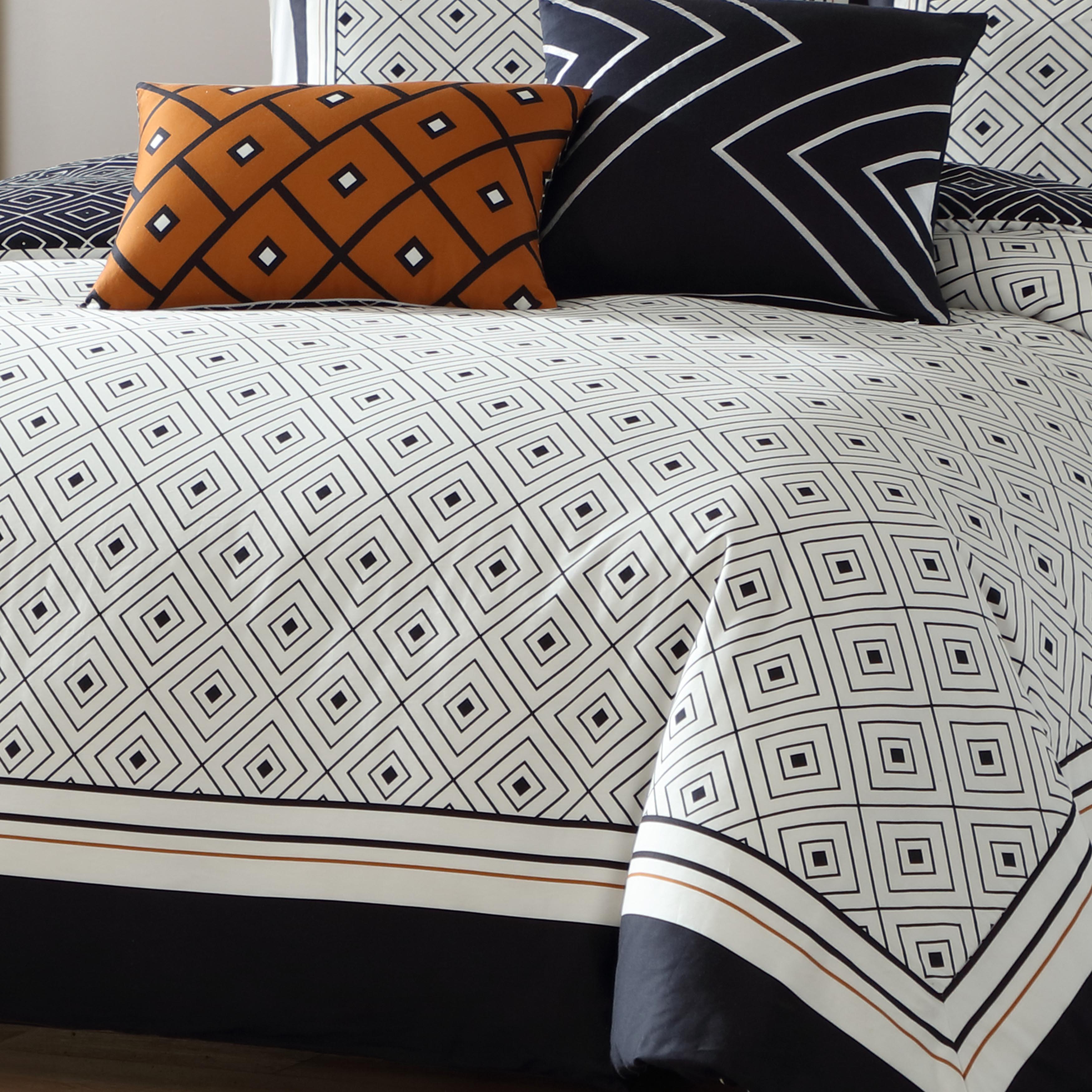 Black and white geometric reversible cotton comforter set with shams and decorative pillows on bed — view 5