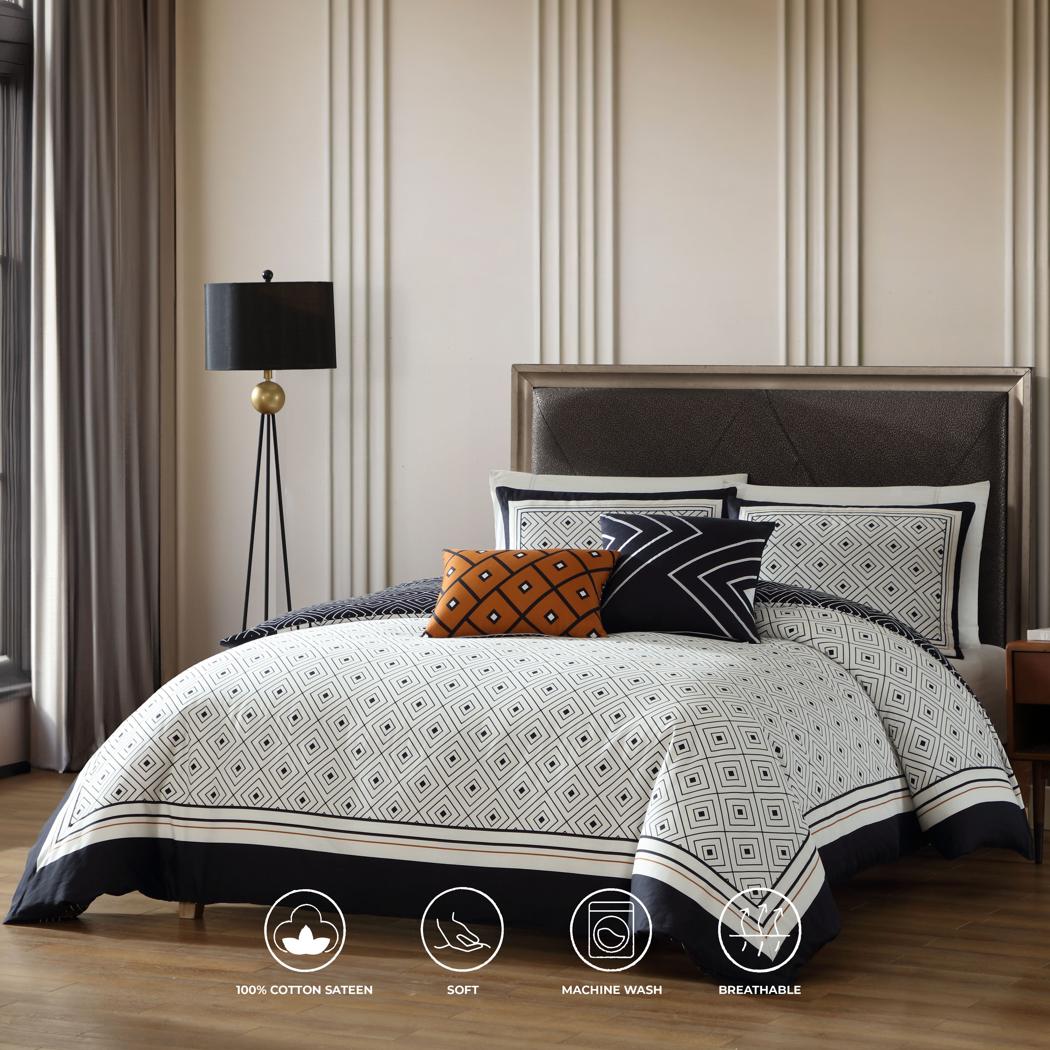 Black and white geometric reversible cotton comforter set with shams and decorative pillows on bed — view 2