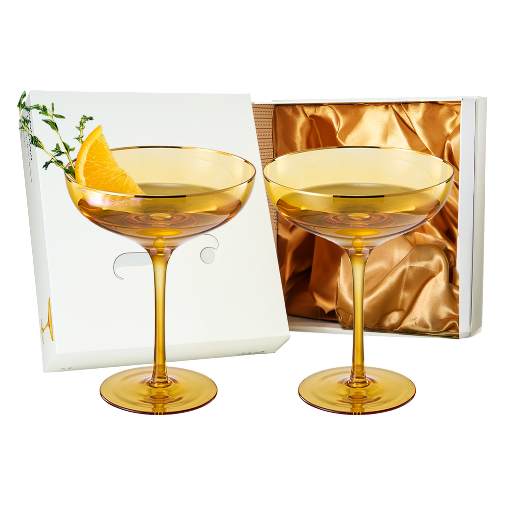 Sunset yellow coupe glasses with elegant gold rims and bubble texture for champagne and cocktails