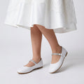 Girls classic leatherette ballerina flats featuring a slip-on design and large decorative front bow