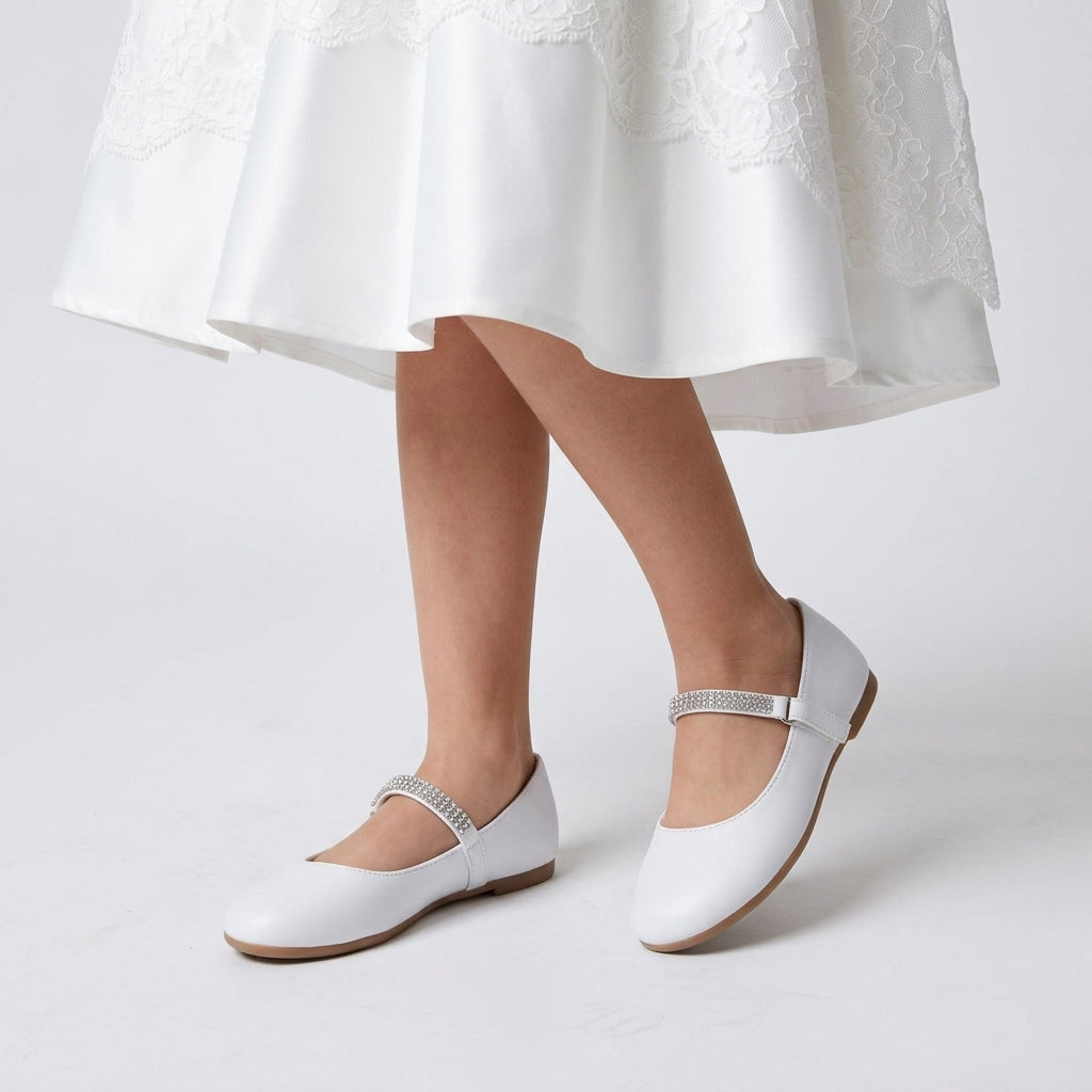 Girls classic leatherette ballerina flats featuring a slip-on design and large decorative front bow
