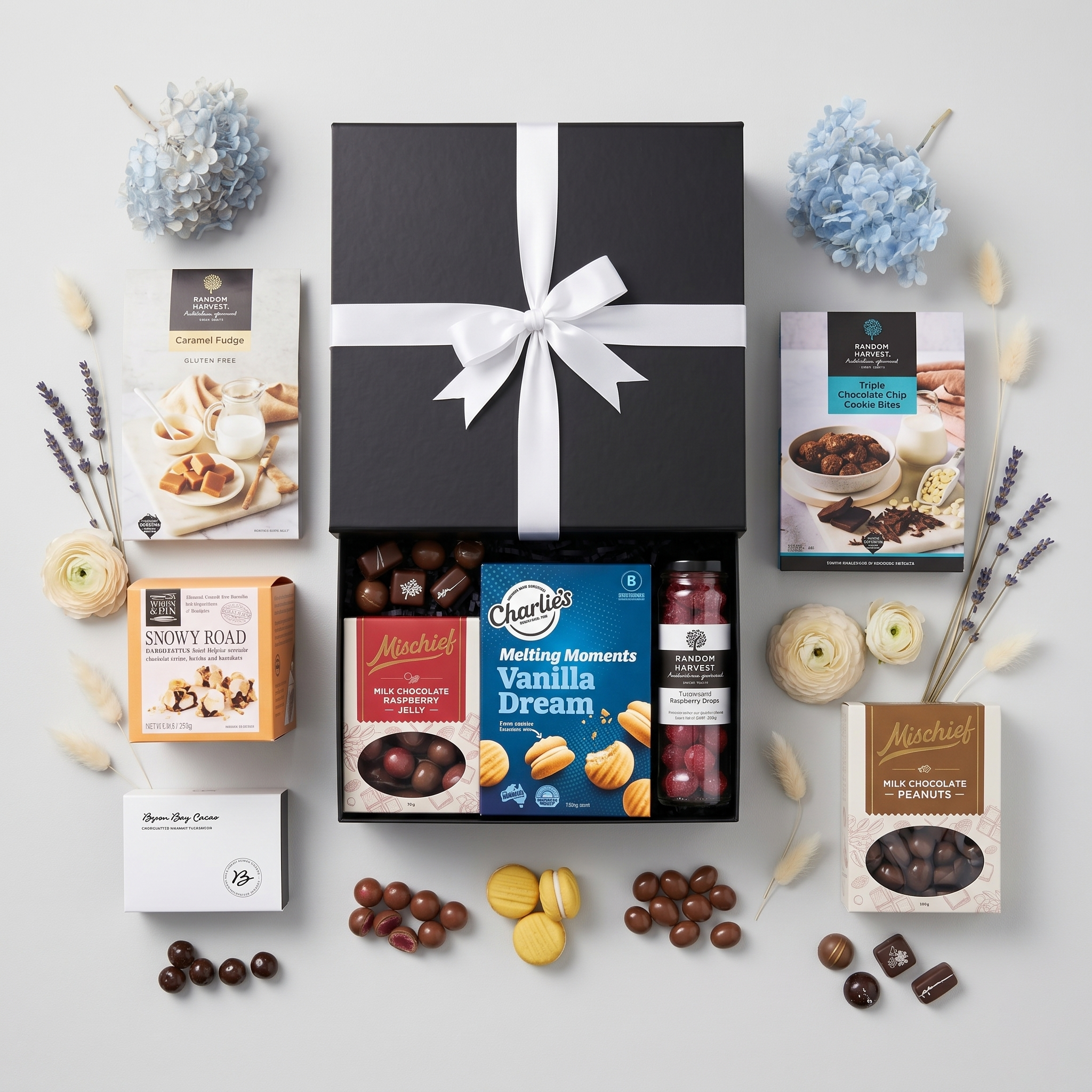 Gourmet Australian snack gift hamper in an elegant black box with a pristine white bow — view 2