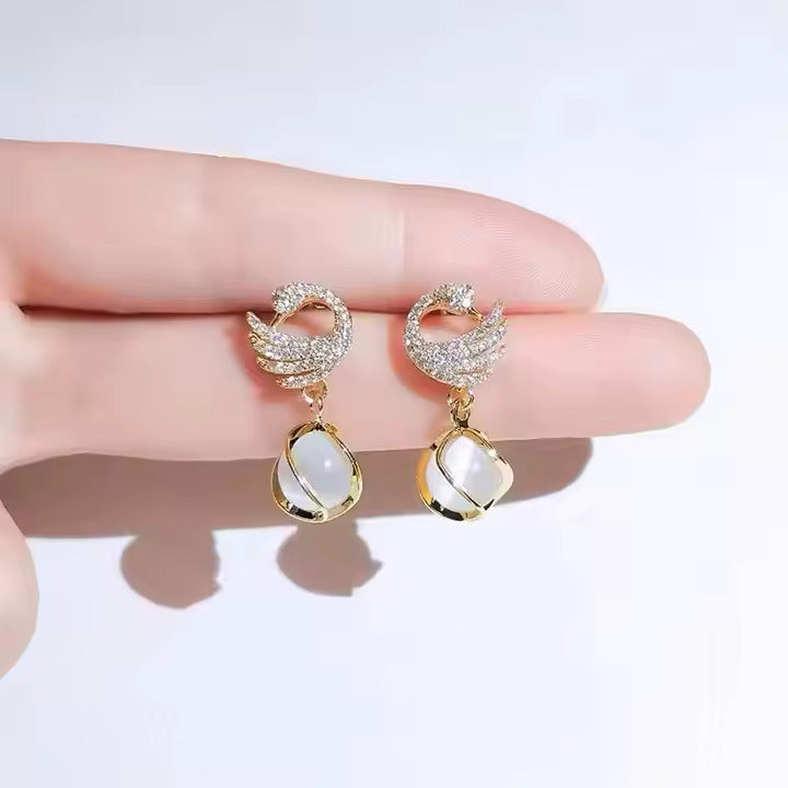 Cozy crystal swan drop earrings with delicate crystal-encrusted wings and dangle design