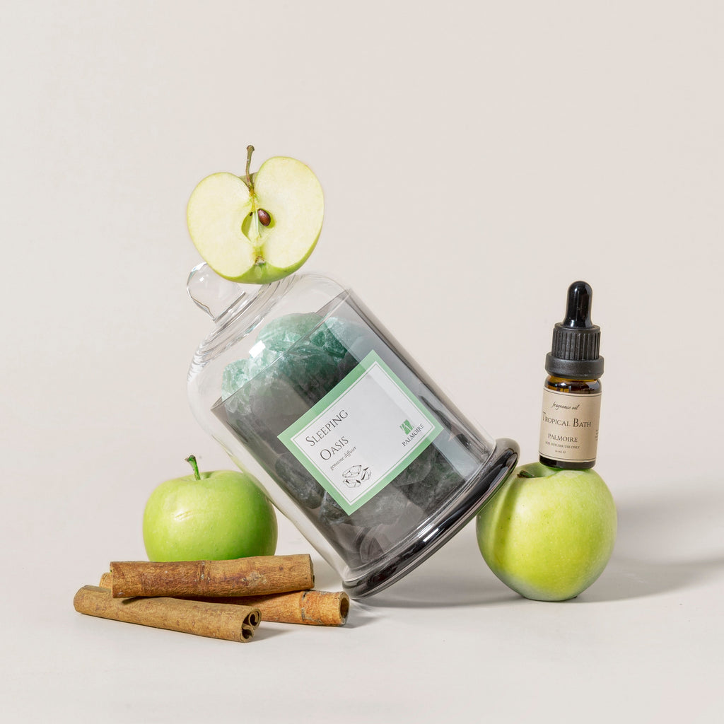 Sleeping Oasis gemstone diffuser with natural stones and Tropical Bath fragrance oil bottle. — view 2