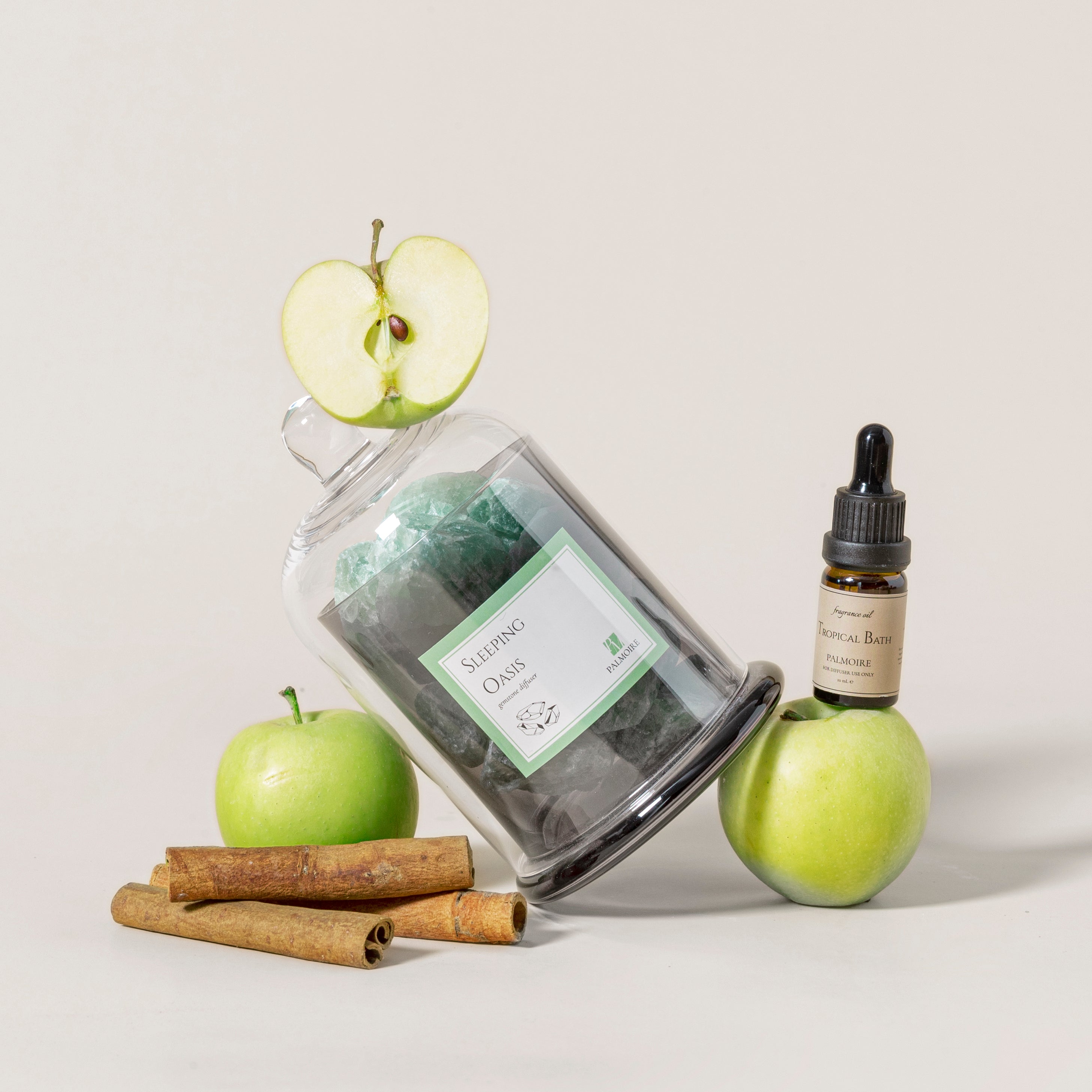 Sleeping Oasis gemstone diffuser with natural stones and Tropical Bath fragrance oil bottle. — view 2