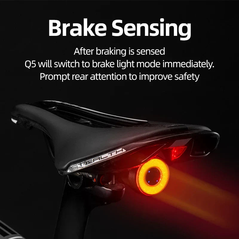 Smart LED bike taillight in black aluminum with glowing red COB light mounted on seat rail — view 2