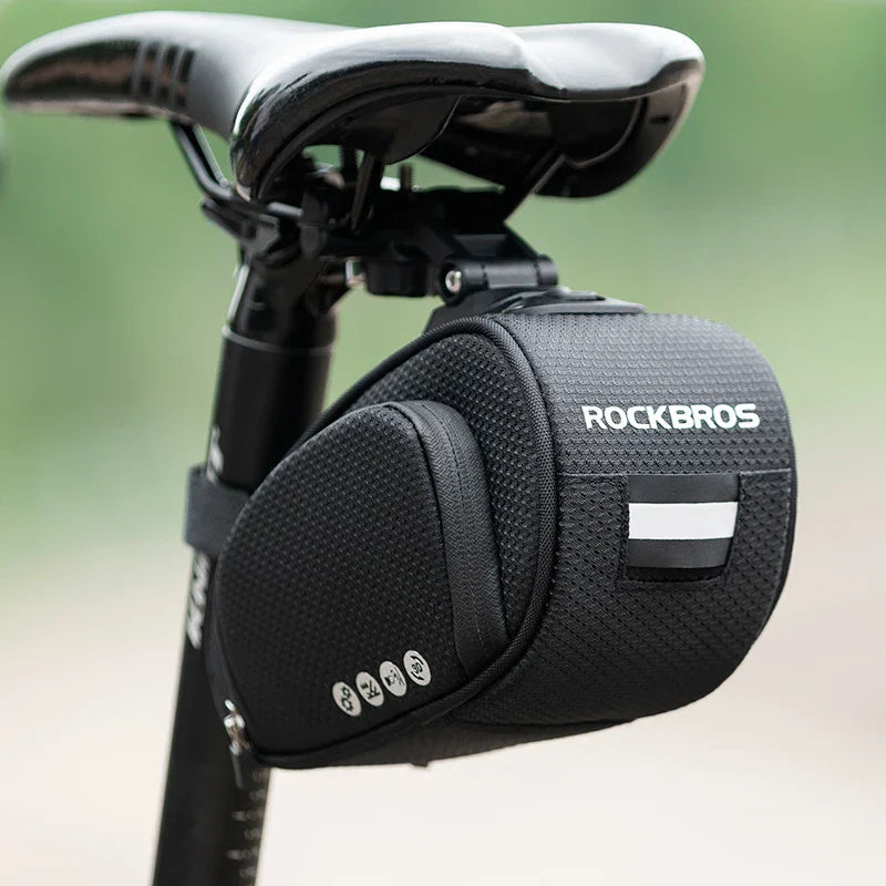 Black rainproof bike saddle bag featuring shockproof padding and quick release bracket mounted under bicycle seat — view 4