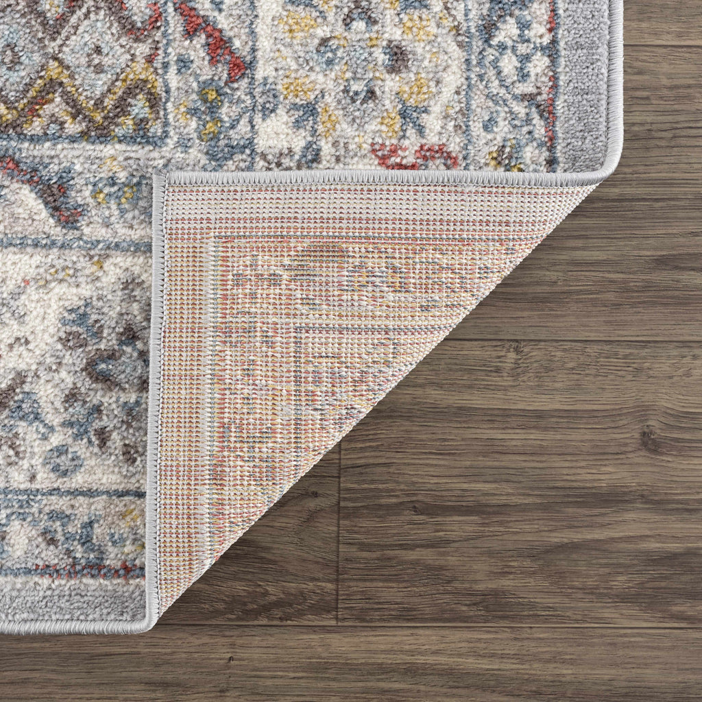 Haymond area rug featuring a traditional multi-color medallion pattern in taupe, blue, and red. — view 5