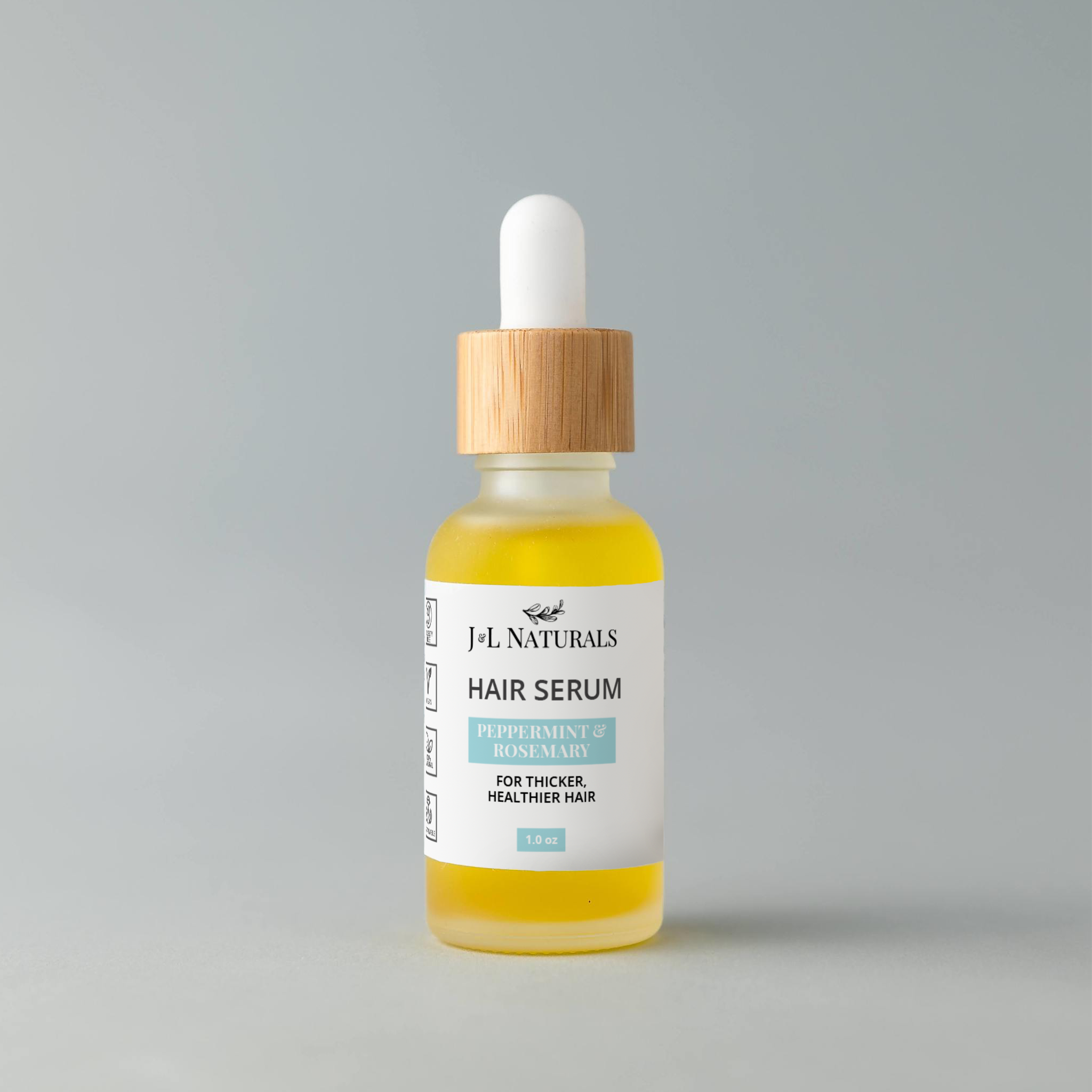 Vegan hair serum in a one ounce glass dropper bottle with natural botanical oils — view 4