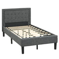 Twin size upholstered bed frame featuring a grey button tufted headboard and under-bed storage clearance