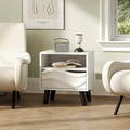 White mid-century modern nightstand featuring a 3D wavy drawer, open shelf, and tapered wooden legs