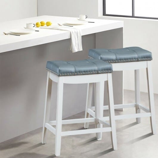 Set of two white backless counter stools featuring wooden legs nailhead trim and saddle seat — view 8