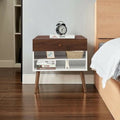 Mid-century modern engineered wood nightstand with single drawer and tapered rubber wood legs.