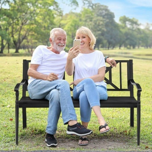 Black powder coated steel patio garden bench with elegant front legs and slatted backrest. — view 2