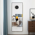 59-inch full length golden mirror with aluminum frame leaning against a modern bedroom wall