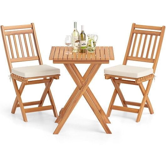 Acacia wood outdoor bistro set with folding table slatted chairs and soft white seat cushions — view 3