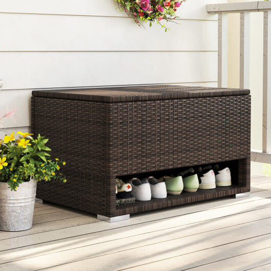 Brown PE rattan outdoor storage bin with waterproof liner and open lid on a patio.