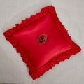 Bright red satin ruffled Euro pillow sham with floral embellishments and vintage ballroom design.