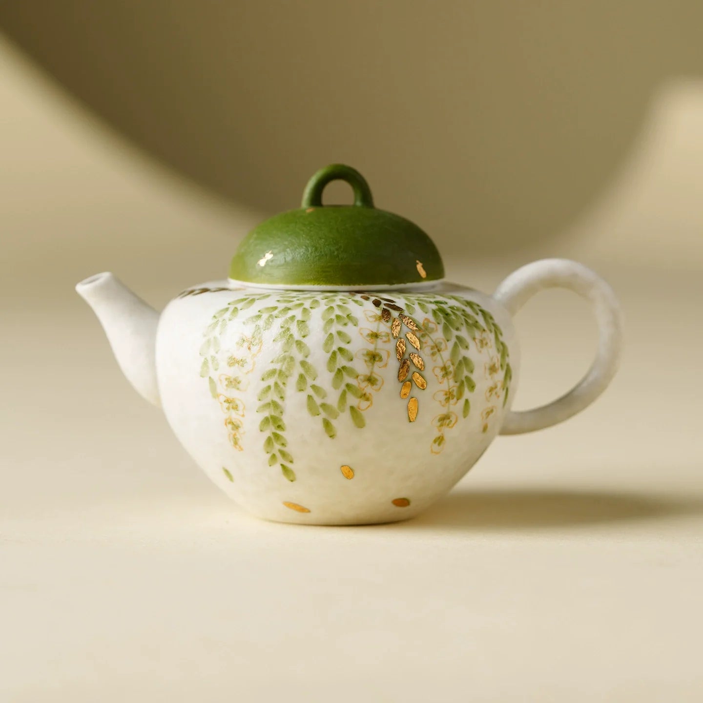 Handmade ceramic green leaf teapot with dome lid and loop handle for traditional tea ceremonies