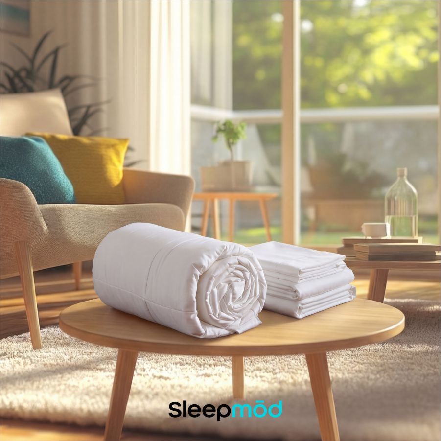 White eucalyptus silk cooling comforter and two matching quilted pillow shams neatly arranged on bed