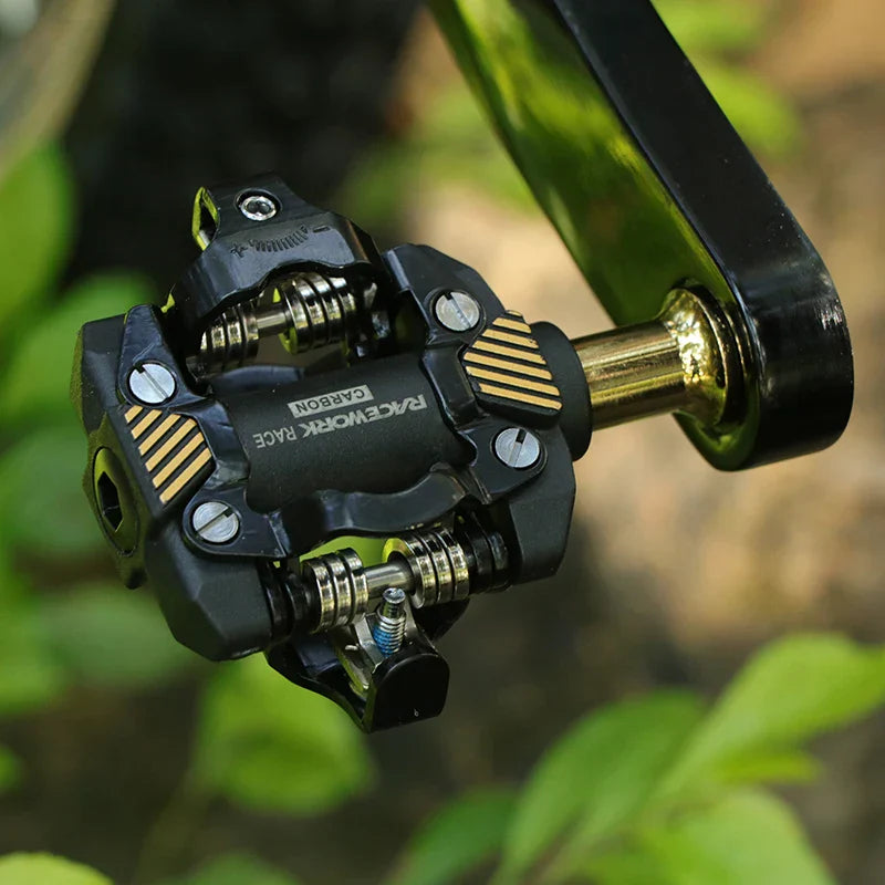 Gold and black carbon composite self-locking SPD mountain bike pedals with chrome steel axles — view 3