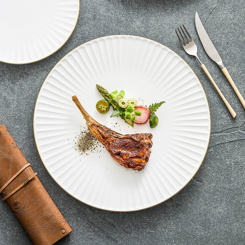 White ceramic dinner plate with pleated texture and a hand-painted gold rim — view 3