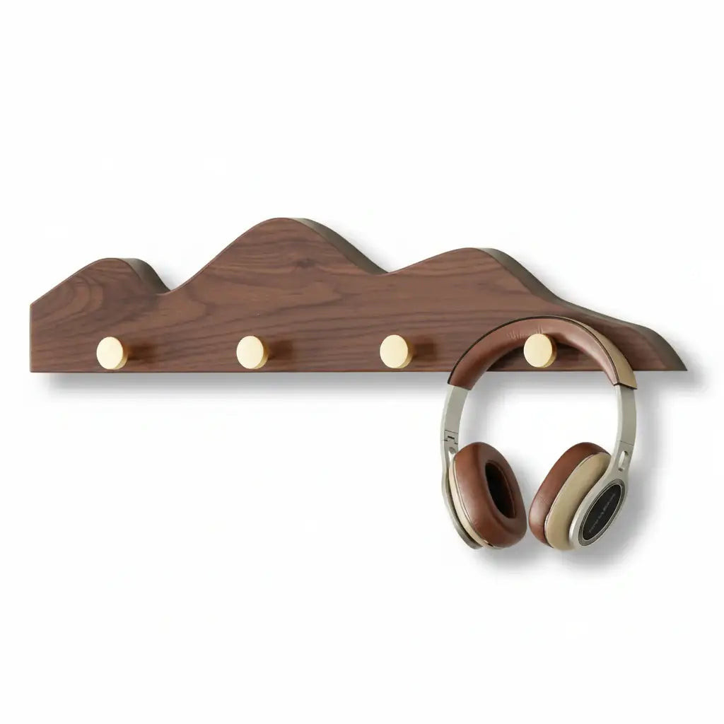 Wooden mountain shape wall hook rack with multiple foldable pegs mounted on a white wall — view 4