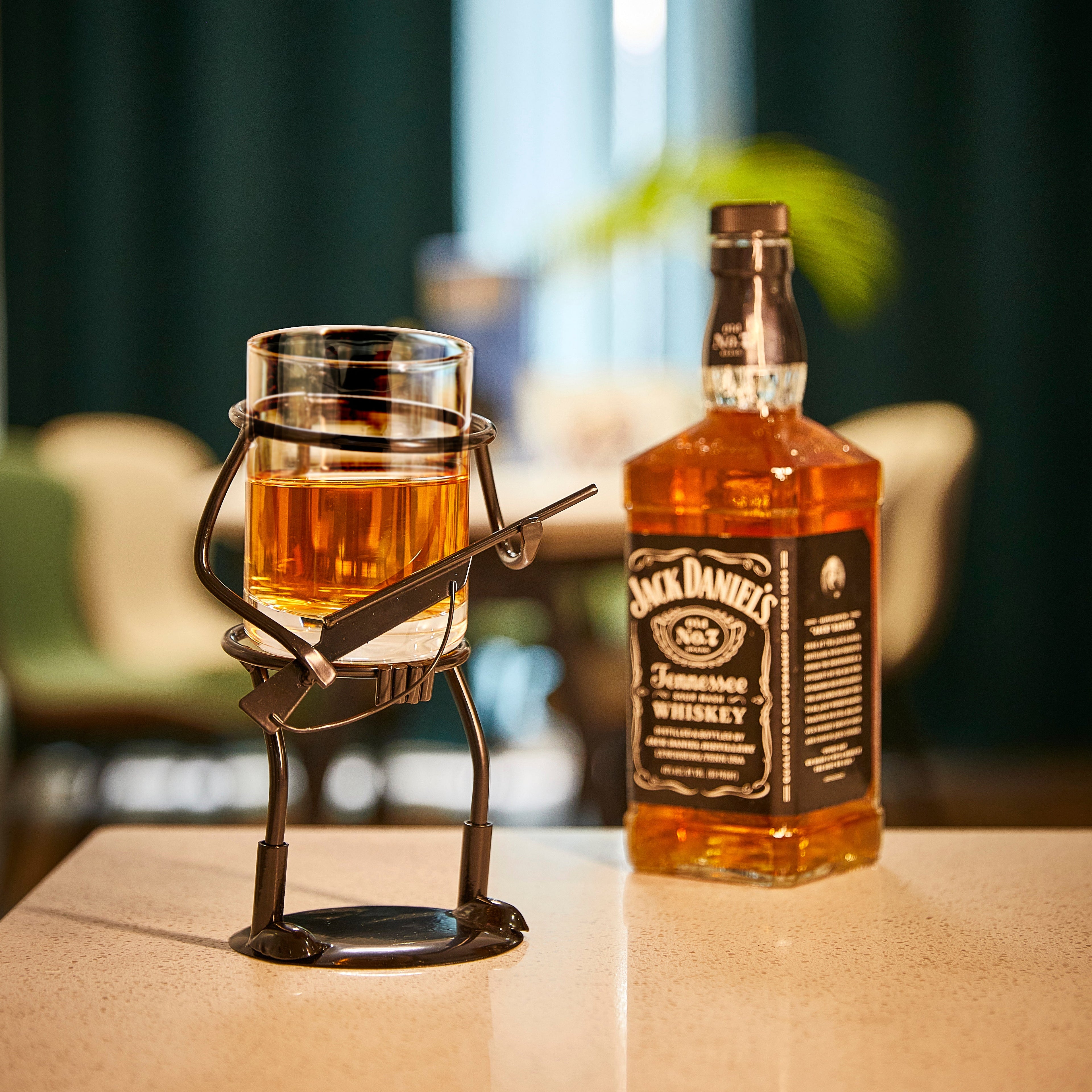 Rifle hunter whiskey glass and rustic metal cup holder with bullet embedded in the side.