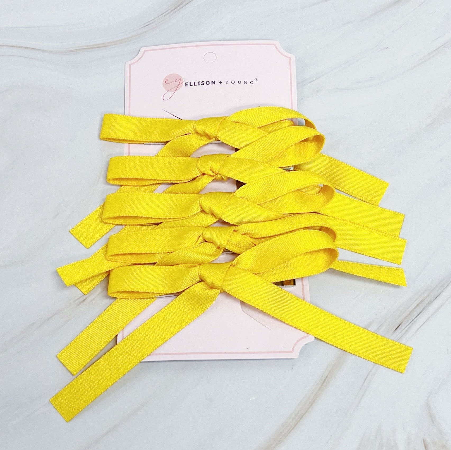 Set of five solid color bow hair clips arranged together, 5 inches wide with medium hold — view 3