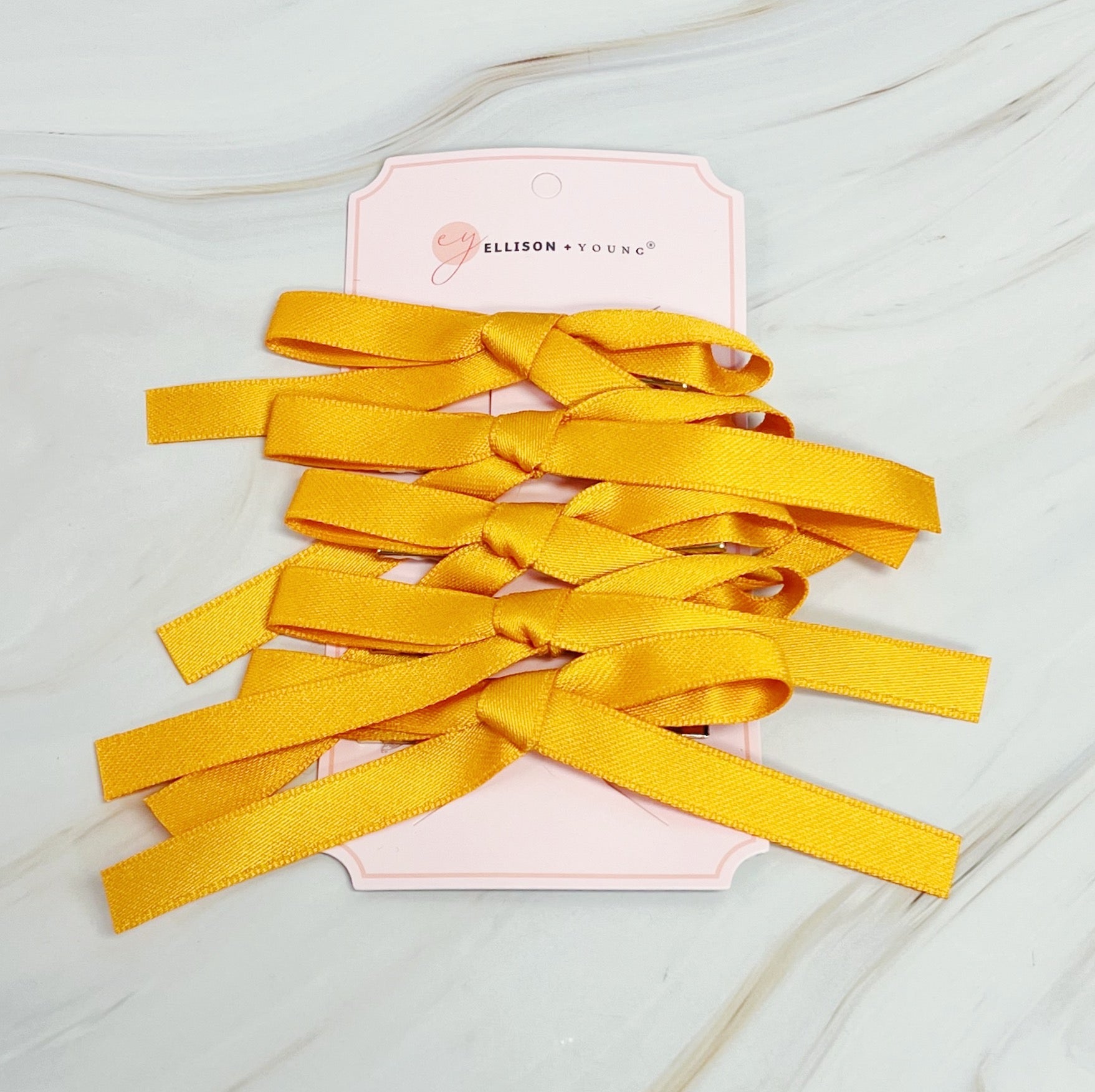 Set of five solid color bow hair clips arranged together, 5 inches wide with medium hold — view 4