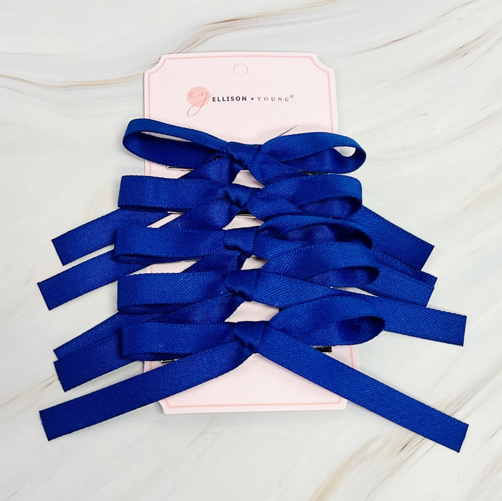 Set of five solid color bow hair clips arranged together, 5 inches wide with medium hold — view 5