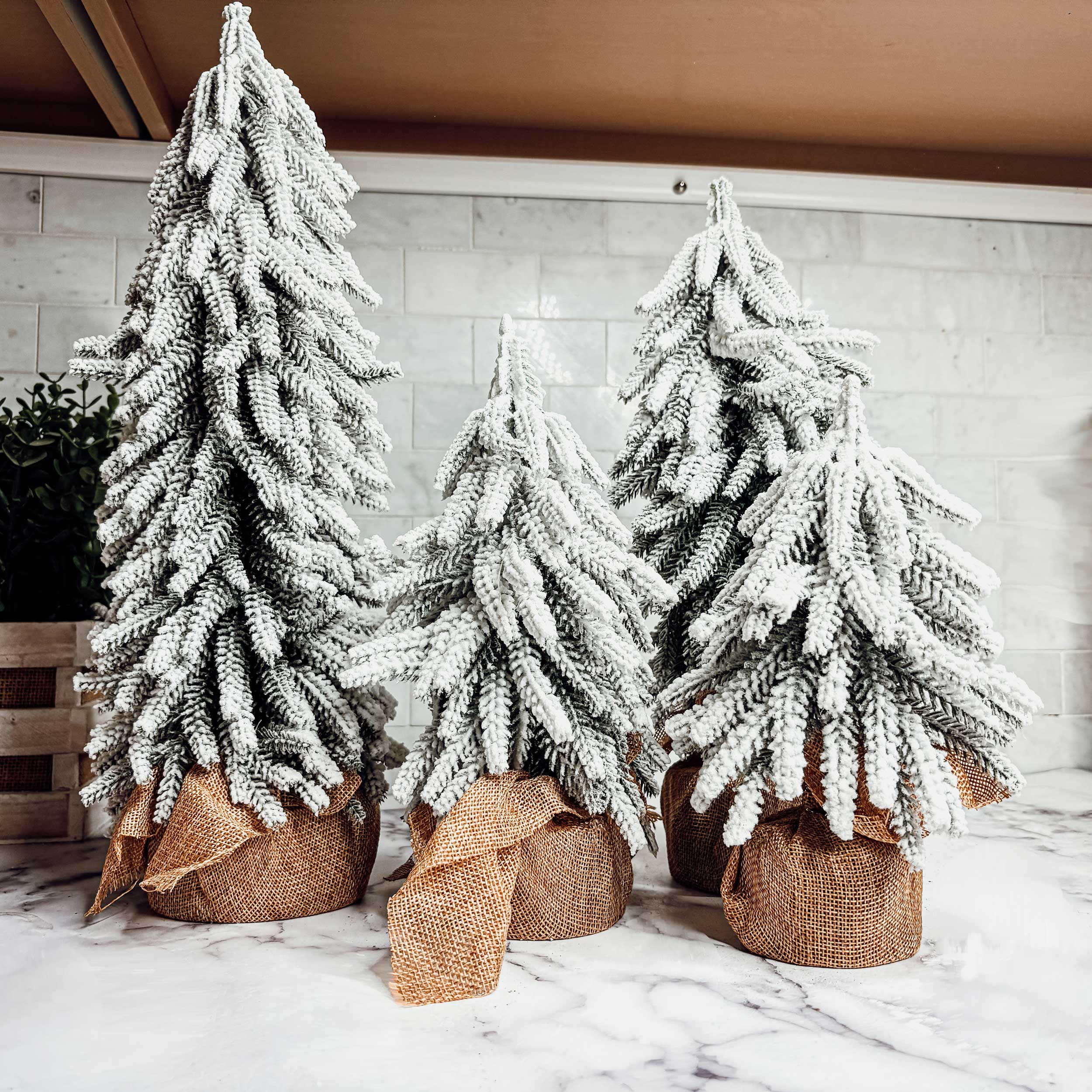 Realistic faux snow-covered tabletop Christmas tree with adjustable branches and rustic jute-wrapped fir wood base — view 4