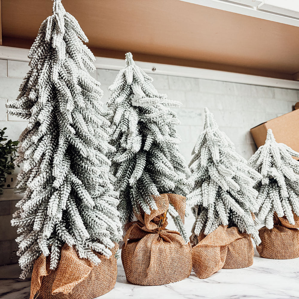 Realistic faux snow-covered tabletop Christmas tree with adjustable branches and rustic jute-wrapped fir wood base — view 2