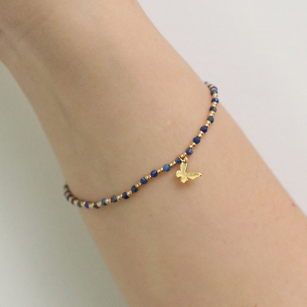 Gemstone butterfly charm stretch bracelet with delicate beads and a miniature metallic butterfly pendant — view 5