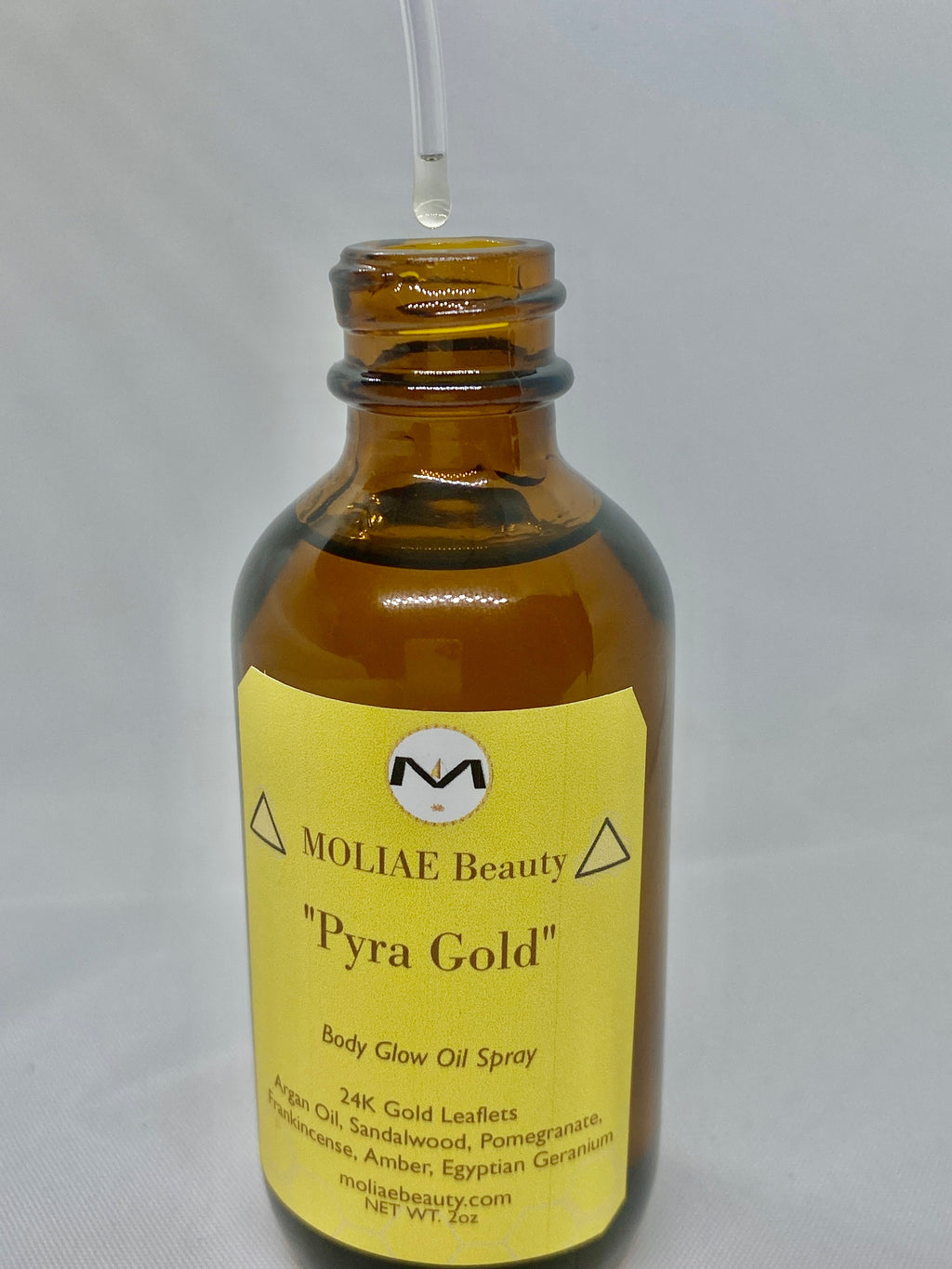Pyra Gold body glow oil spray bottle with 24kt gold leaflets and Moroccan Argan oil — view 3